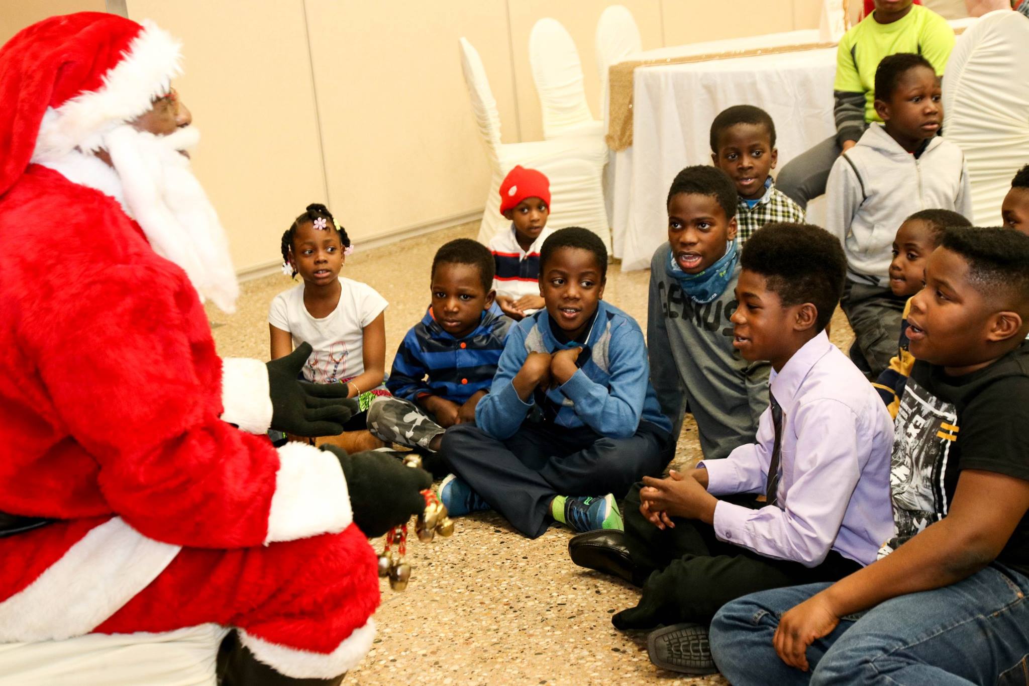 children sitting aound father christmas